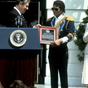 President Ronald Reagan presents Michael Jackson with Presidential Public Safety Communication Award at White House ceremony May 14, 1984