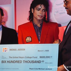 Michael Jackson presents a 0,000 check to the United Negro College Fund at a press conference held by his sponsor Pepsi in New York, NY, on March 1, 1988.